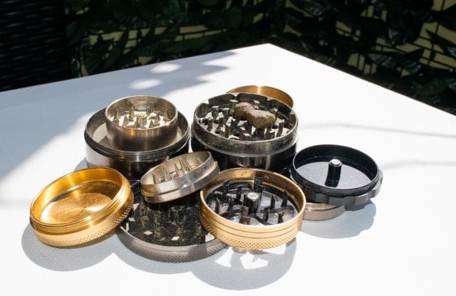 Weed grinders disassembled to show the parts