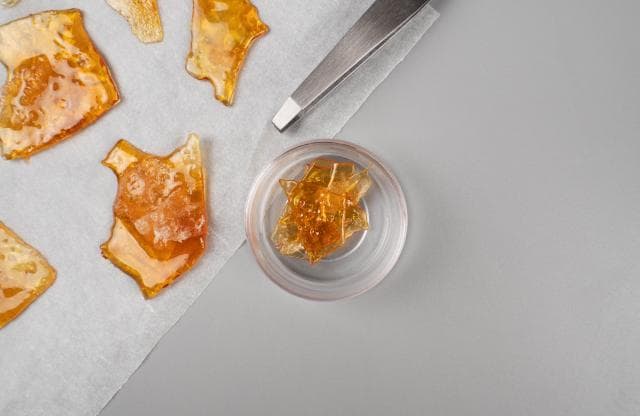 Shattered pieces of cannabis wax on a sheet