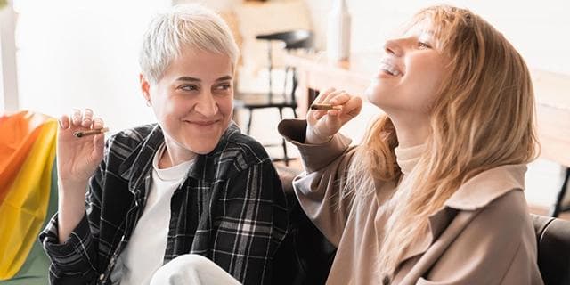 Two individuals, with one appearing to be in the midst of experiencing the effects of a cannabis high.