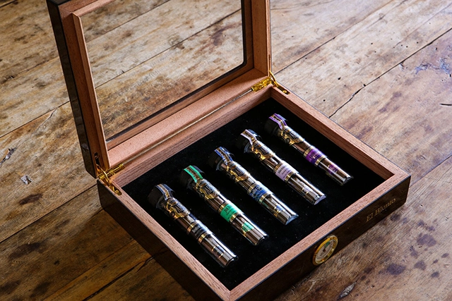 An open wooden box with compartments for storing various cannabis products, exemplifying an organized way to keep cannabis fresh and discreet.