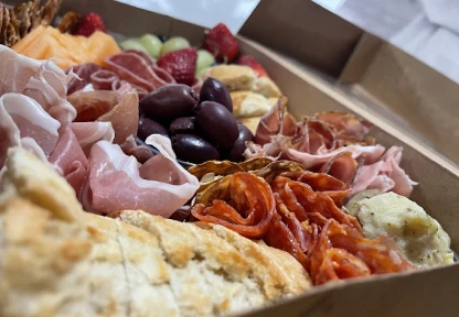 A selection of Italian cured meats, cheeses, and bread at Bella Napoli Pizzeria