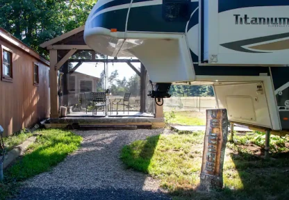 A cozy RV park offering a unique stay in a wooded area, showcasing a blend of adventure and comfort.